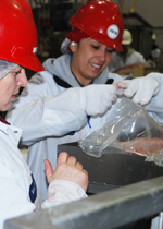 Two Truebridge employees checking the bagging on the fabrication line.